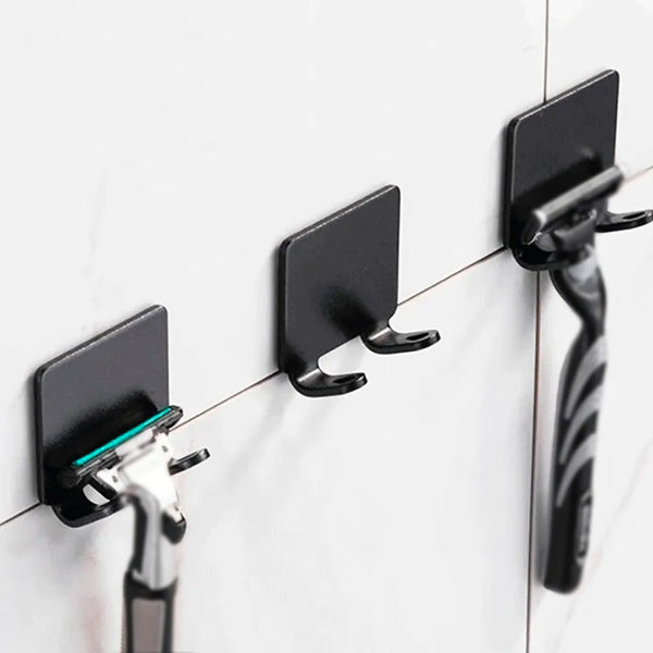 Self-adhesive razor holder for tiles